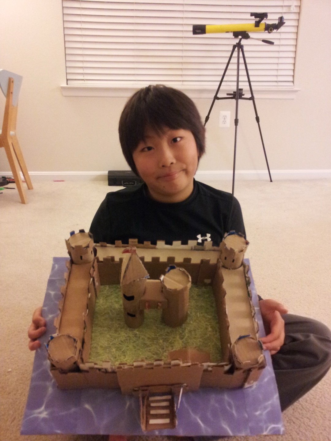 Bryan as a kid, holding a cardboard castle