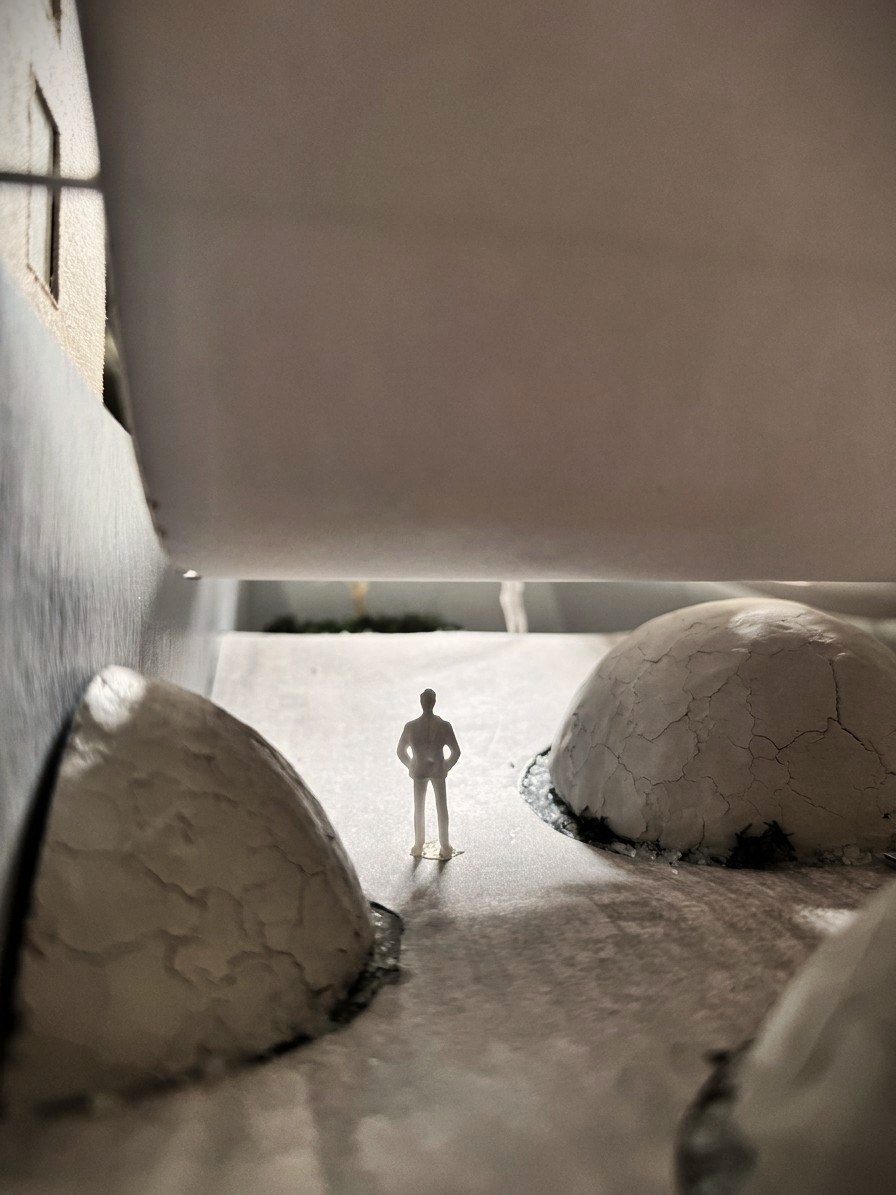 Model view — figure between mounds beneath the canopy